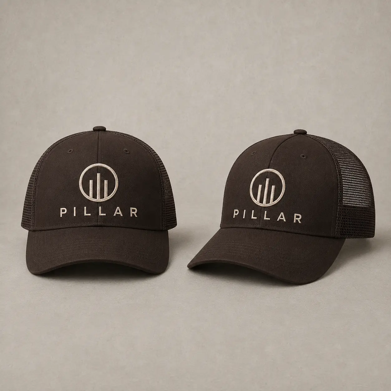 Front and three-quarter views of the brown embroidered PILLAR trucker hat