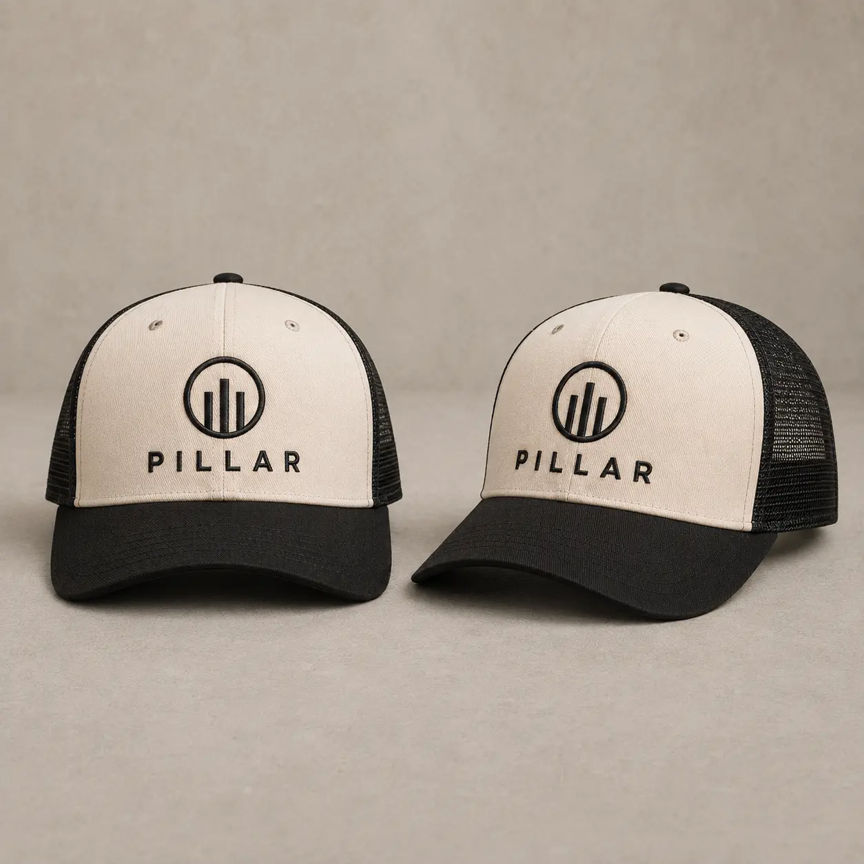 Front and three-quarter views of the off-white and black embroidered PILLAR trucker hat