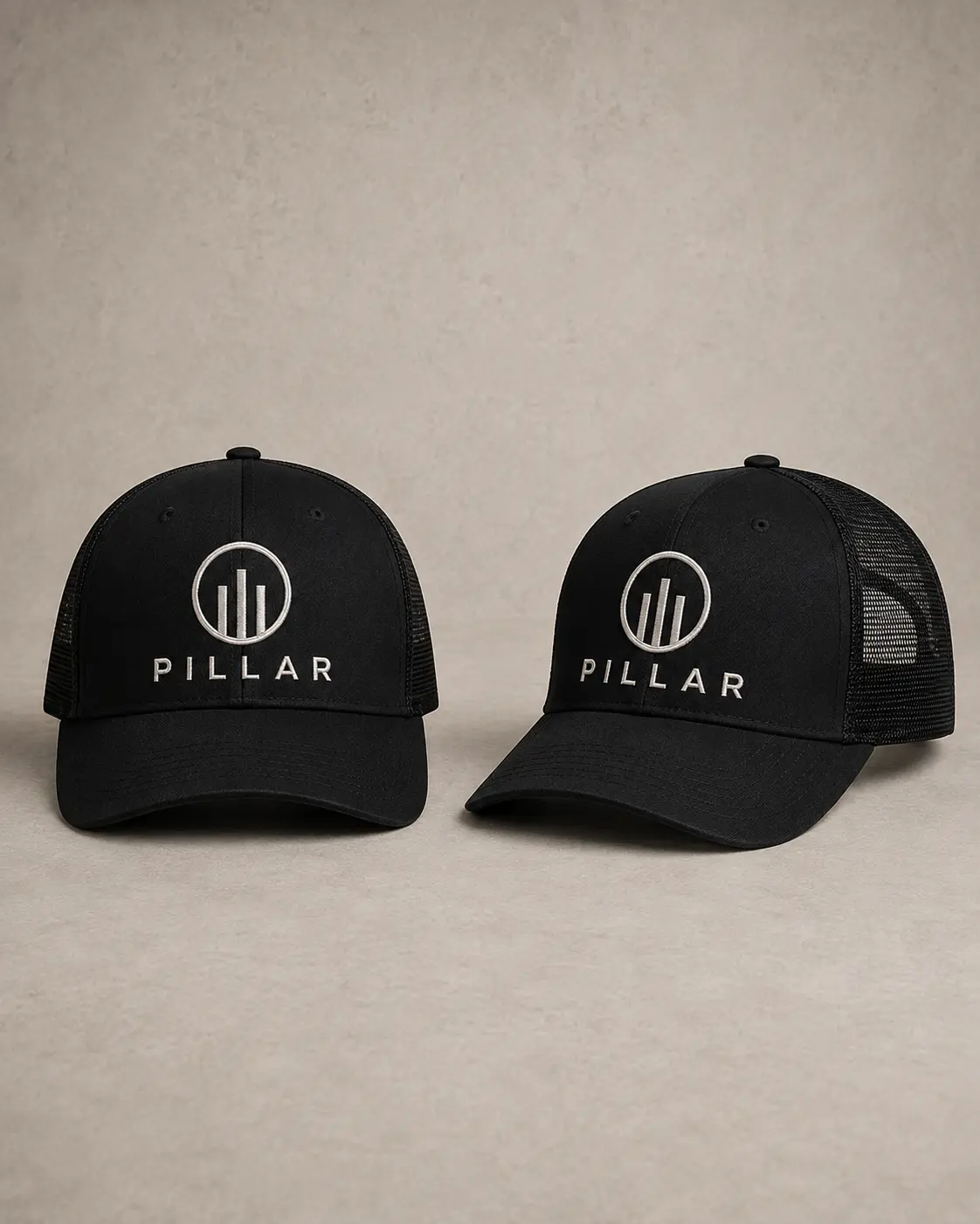 Front and three-quarter views of the black embroidered PILLAR trucker hat